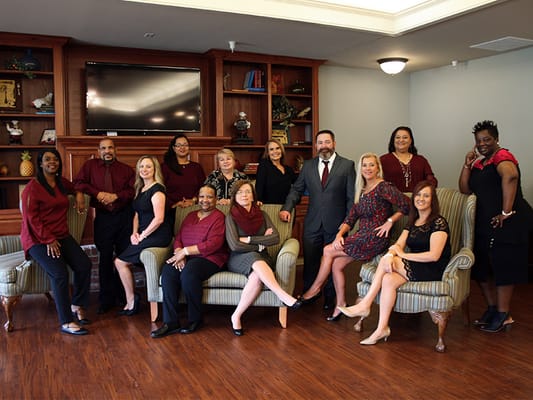 Staff members posing together in a common area
