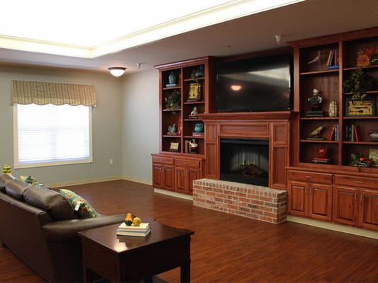 Cozy common area with a fireplace and bookshelves