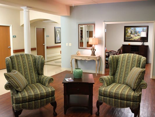 Cozy common area with two colorful chairs and a side table
