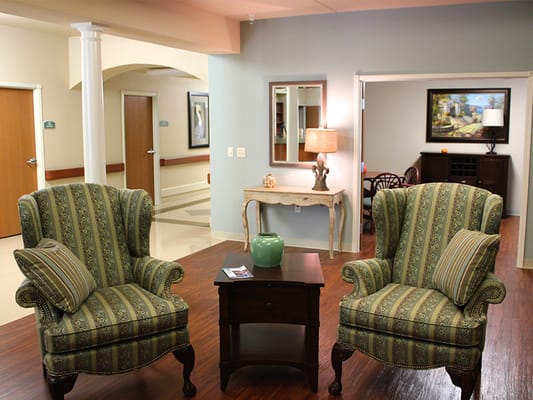 Cozy common area with two colorful chairs and a side table