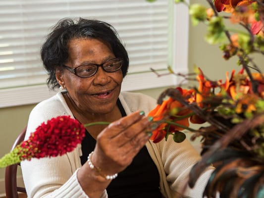 Resident arranging flowers in a common area