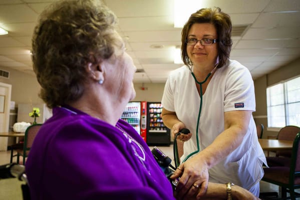 Healthcare professional checking a resident's vitals