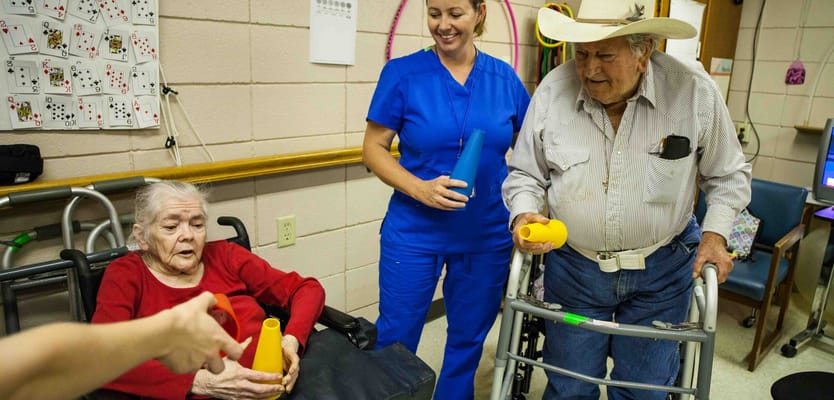 Residents participating in a group activity with staff