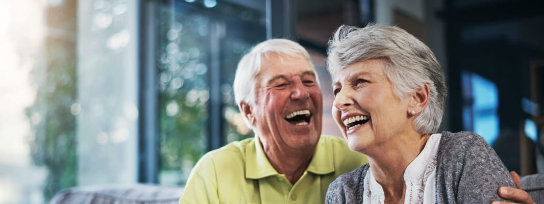 Happy elderly couple enjoying a joyful moment indoors