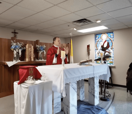 A priest leading a service in a chapel