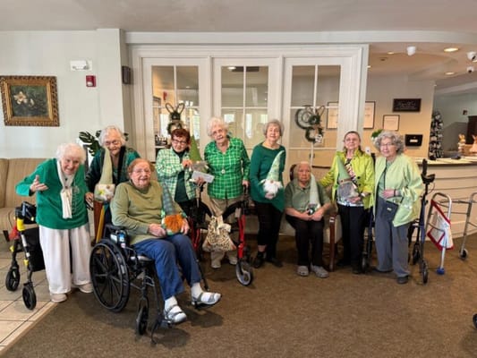 Residents celebrating with green attire in a common area