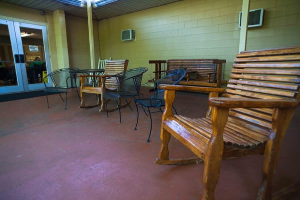 Outdoor seating area with wooden benches and chairs