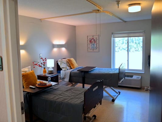 Bright shared bedroom with two beds and natural light