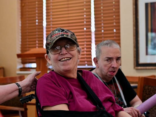 Residents smiling together in a cozy common area