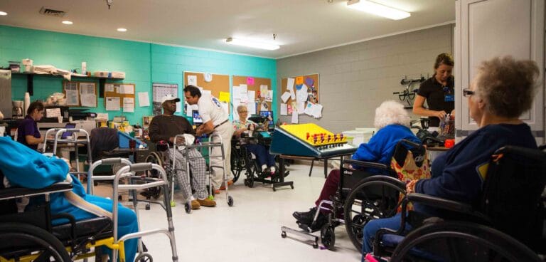 Residents and staff engaged in a lively activity room