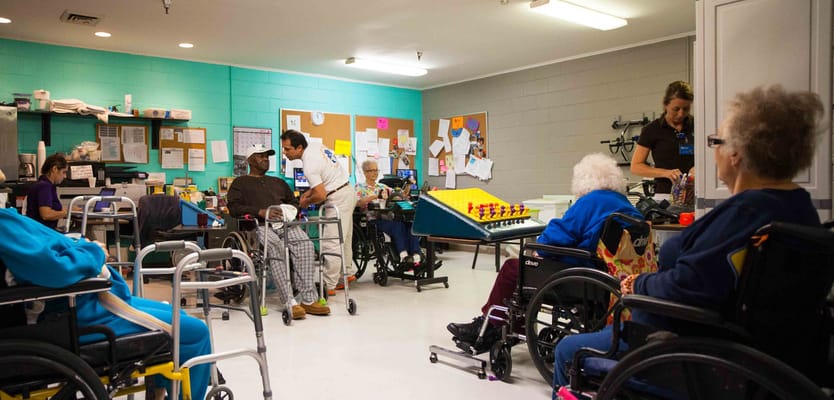 Residents and staff engaged in a lively activity room