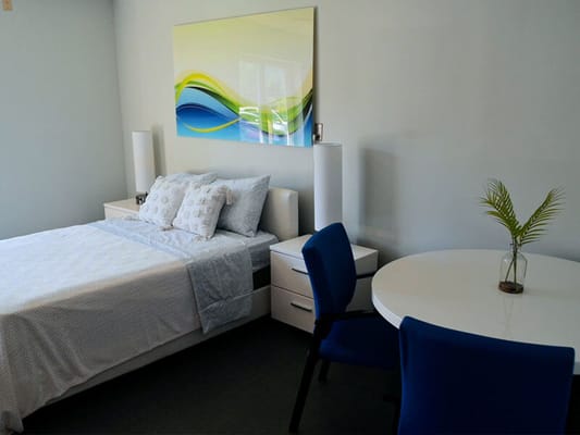 Modern resident room with bed and table