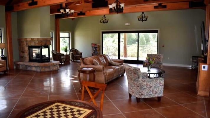 Spacious common area with comfortable seating and fireplace