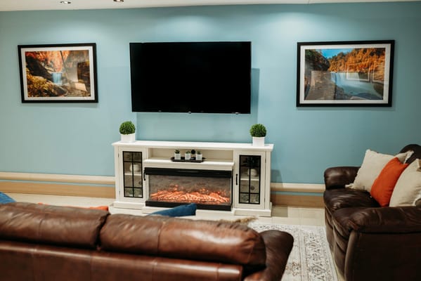 Cozy lounge area with comfortable seating and decorative artwork