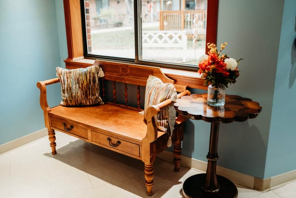 Cozy seating area with flowers and decorative pillows