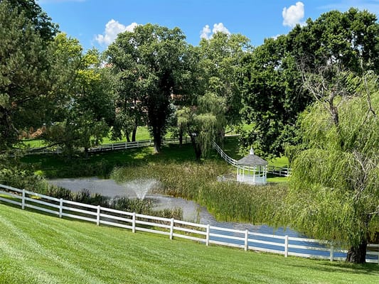 Scenic view of a pond and gazebo in a landscaped area