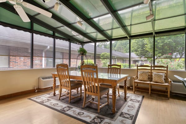 Bright sunroom with dining table and chairs