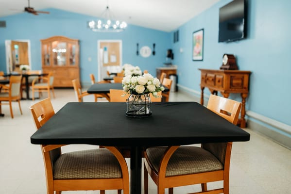 Dining area with tables and floral centerpieces