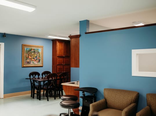 Interior view of a common area with a table and artwork