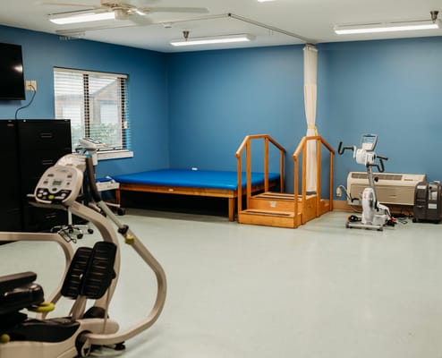 Therapy room with exercise equipment and blue walls