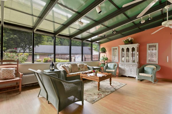 Bright sunroom with comfortable seating and plants