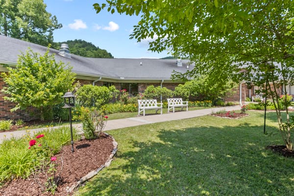 Well-maintained outdoor pathway with benches and flowers