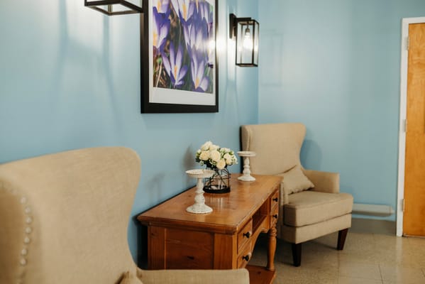 Cozy lobby area with chairs and floral decor