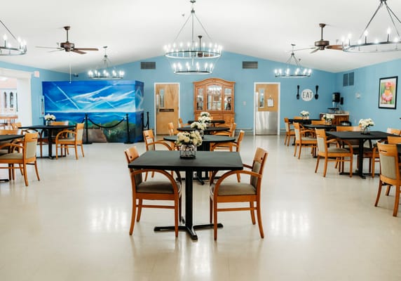 Bright dining area with tables and flowers