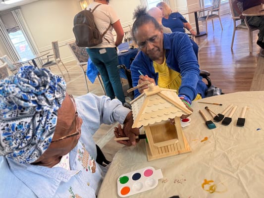 Residents participating in a craft activity indoors