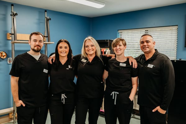 Staff members posing together in a facility