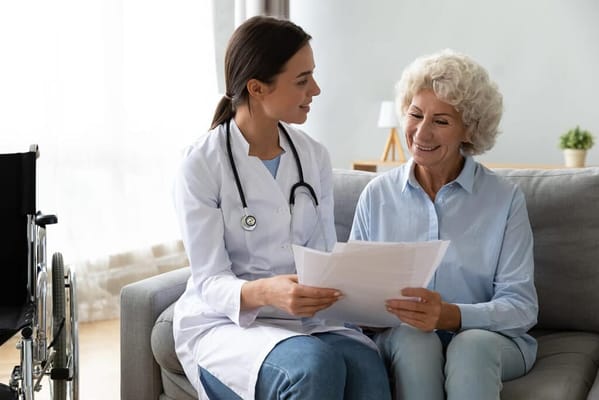 A caregiver and a resident discussing documents