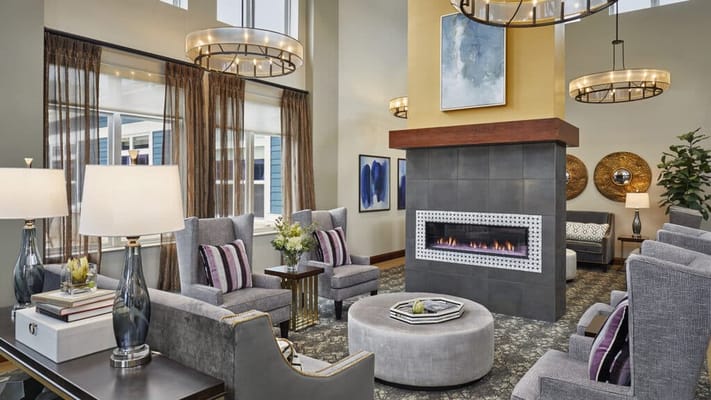 Bright common area with comfortable seating and fireplace