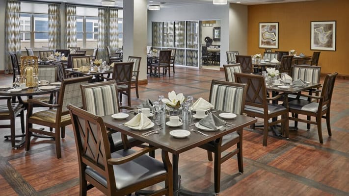 Dining area set for a meal with elegant table settings
