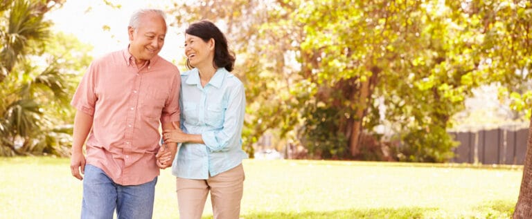 Couple walking together in a sunny park