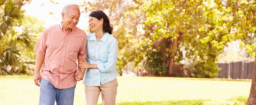 Couple walking together in a sunny park