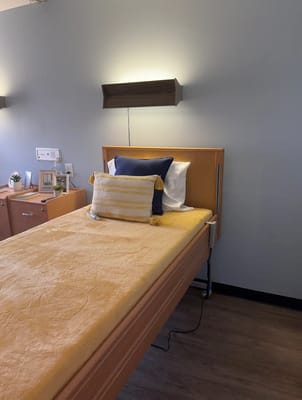 Well-furnished private resident room with a cozy bed