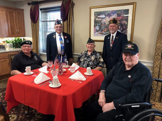 Veterans celebrating at a dining table with festive decor