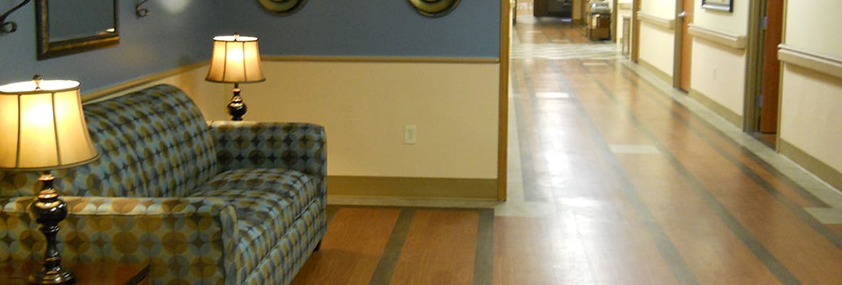 Interior hallway featuring a patterned sofa and lamps