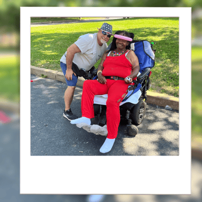 Resident enjoying time outdoors with staff member