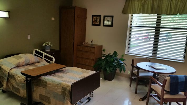 Cozy resident room with a bed and sitting area