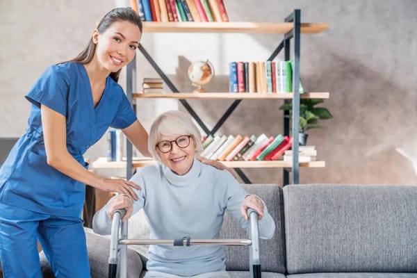 A caregiver assisting a smiling senior resident