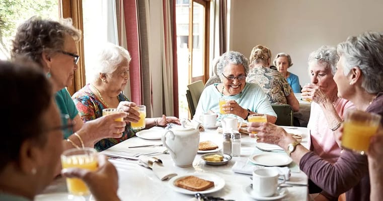 Residents enjoying drinks together in a dining area