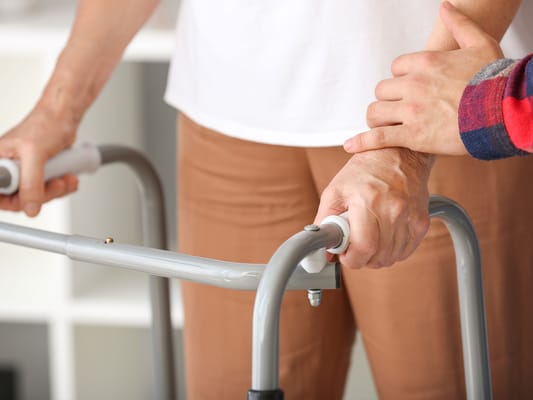 Close-up of a caregiver assisting a resident
