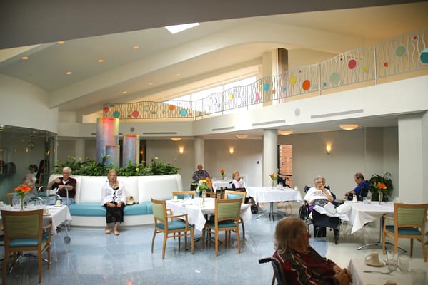 Residents enjoying meals in a bright dining area