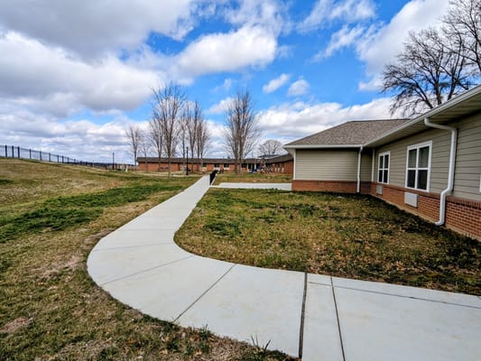 Pathway leading through outdoor space of the facility