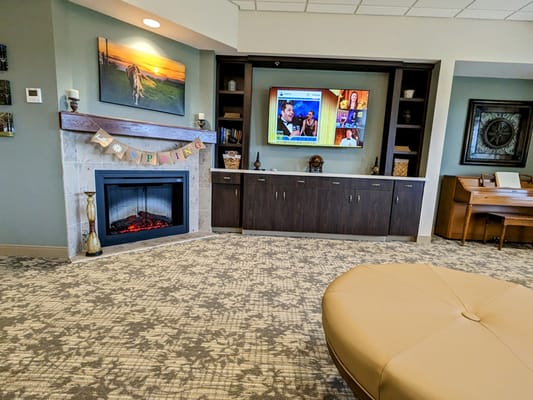 Interior common area with fireplace and television