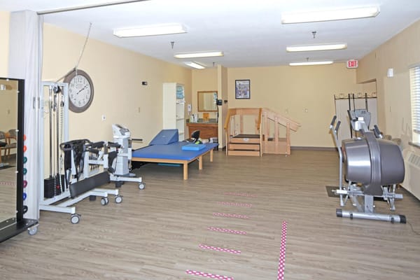 Interior view of a therapy room with exercise equipment