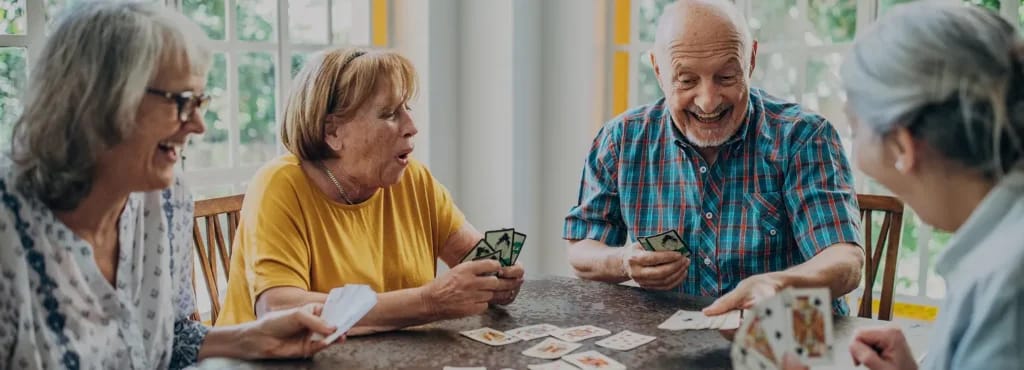 Residents enjoying a card game in a common area