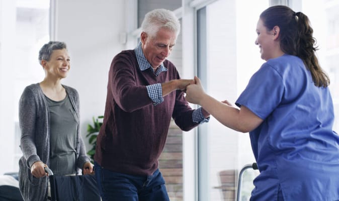 Staff assisting a resident in an indoor setting