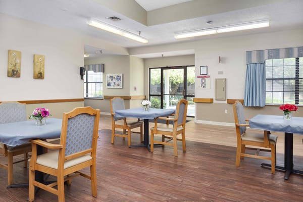 Bright dining area with tables and flowers